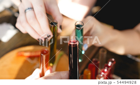 Test tubes with multi-colored liquid. Alcohol in test tubes dark bar 54494928