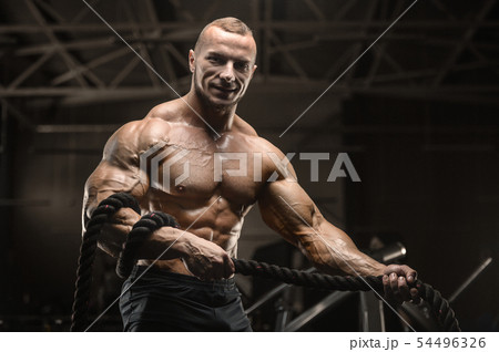 fitness athletes training using battle ropes fitness athletes training using battle ropes 54496326