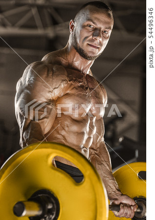 muscular bodybuilder fitness men doing arms 54496346