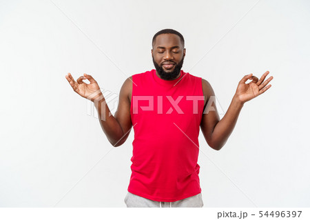 Young african american sport man do meditating isolate over grey background. 54496397