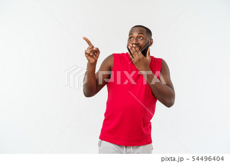 Young sport black man over an grey background very surprise. Young sport black man over an grey background very surprise. 54496404