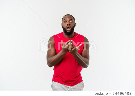 Young sport black man over an grey background very scared and afraid hidden Young sport black man over an grey background very scared and afraid hidden 54496408