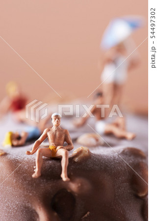 miniature people in swimsuit on an ice cream bar 54497302