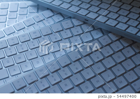 closeup of computer keyboards on a black dark desk 54497400