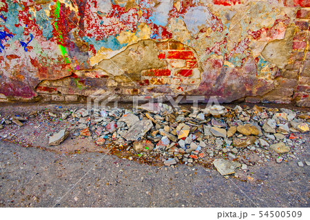 Damaged wall with building garbage beneath 54500509