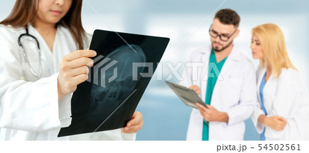 Doctor working in hospital with other doctors. 54502561