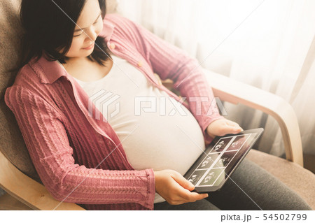 Happy pregnant woman and expecting baby at home. 54502799