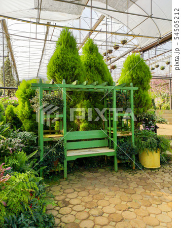 Wooden bench at garden flowers design Wooden bench at garden flowers design 54505212