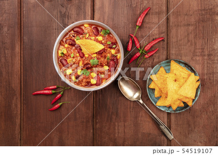 Chili con carne, a traditional Mexican dish with red beans, cilantro leaves, ground meat, and chili 54519107