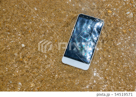 Broken crashed smartphone is lying in the water. 54519571