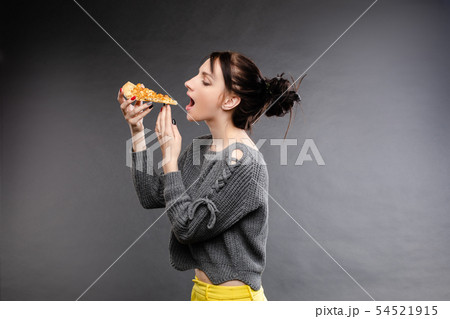Young caucasian woman with tail eating piece of 54521915