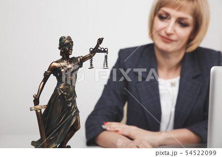 Jurisprudence concept. Woman advocate at the desk sitting isolated. 54522099