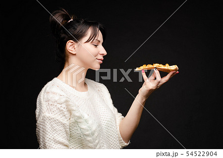 Young caucasian woman with tail eating piece of 54522904
