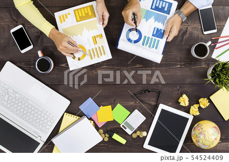 Two people working in an office Two people working in an office 54524409