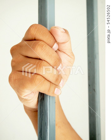 hands behind bars 54526502