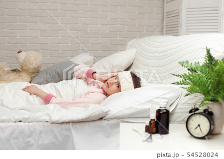 sick cold little child girl lies in bed 54528024