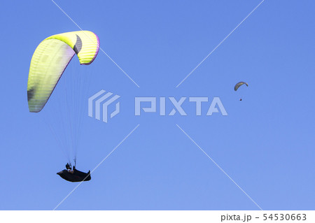 Paragliding in the blue sky as background extreme Paragliding in the blue sky as background extreme 54530663