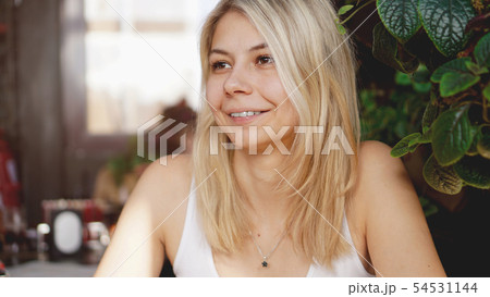 Portrait of smiling blonde sitting at coffee shop 54531144