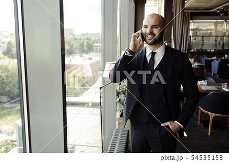 Close up of handsome businessman, working on laptop in restaurant Close up of handsome businessman, working on laptop in restaurant 54535153