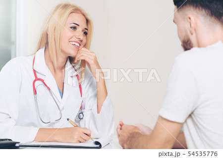 Woman Doctor and Male Patient in Hospital Office 54535776