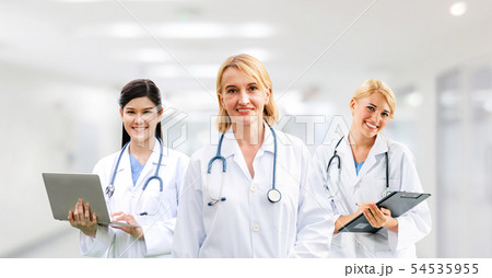 Doctor working in hospital with other doctors. 54535955