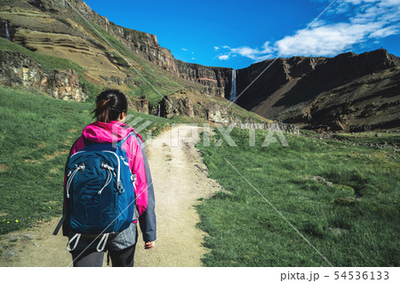Traveler hiking at Hengifoss Waterfall, Iceland. Traveler hiking at Hengifoss Waterfall, Iceland. 54536133