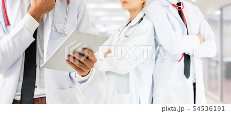Doctor working in hospital with other doctors. 54536191