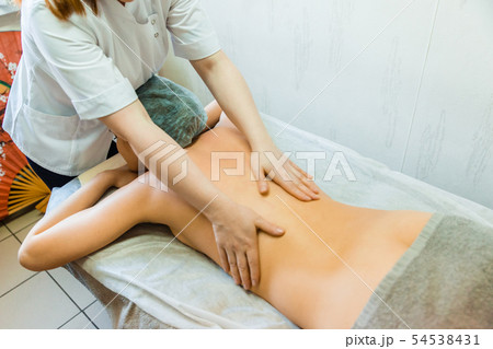 The concept of back massage treatment. Female The concept of back massage treatment. Female 54538431