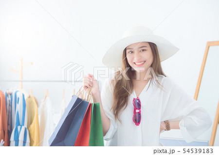 Beautiful asian woman holding shopping bags  54539183