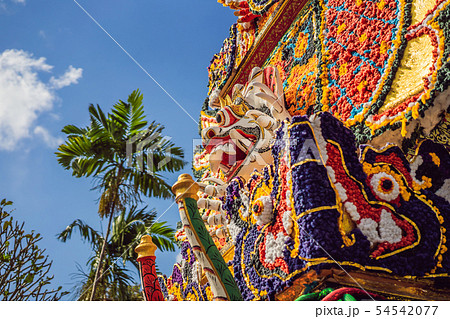 Bade cremation tower with traditional balinese sculptures of demons and flowers on central street in Bade cremation tower with traditional balinese sculptures of demons and flowers on central street in 54542077