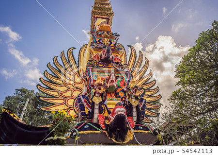 Bade cremation tower with traditional balinese sculptures of demons and flowers on central street in Bade cremation tower with traditional balinese sculptures of demons and flowers on central street in 54542113