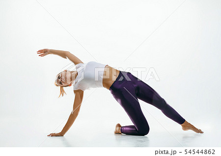 Sporty young woman doing yoga practice isolated on white background 54544862