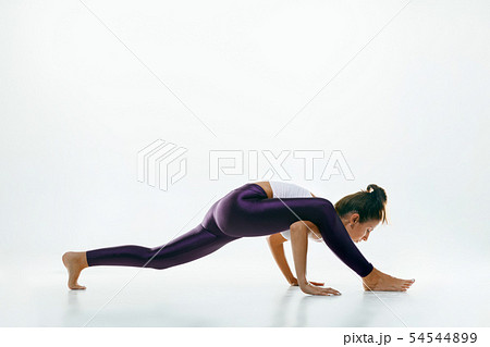 Sporty young woman doing yoga practice isolated on white background 54544899