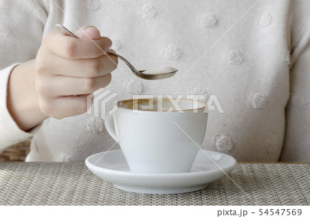 Closeup photo of a woman drinking coffee from a Closeup photo of a woman drinking coffee from a 54547569