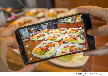 taking photo at breakfast 54548730