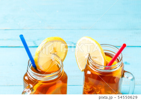Iced tea in a glass jar with lemon. 54550629