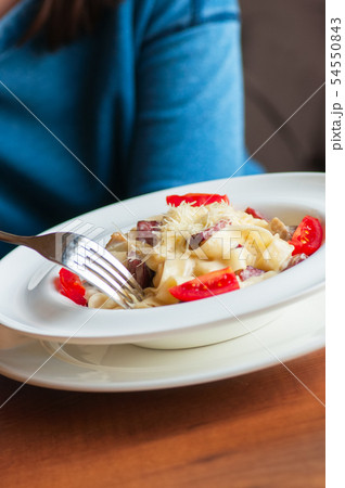 Creamy carbonara pasta in a white plate 54550843