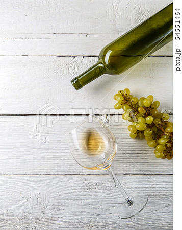 Picture on top of wine glass with wine, grapes, bottle 54551464