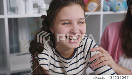 Mother and daughter on consultation at the doctor's office. Portrait of a teenage girl to Mother and daughter on consultation at the doctor's office. Portrait of a teenage girl to 54552047