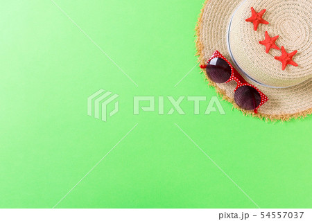 Beach hat with seashells on brown green table. Beach hat with seashells on brown green table. 54557037