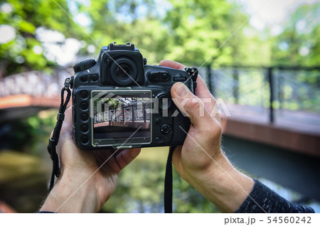 A photographer is photographing the bridge. He is A photographer is photographing the bridge. He is 54560242