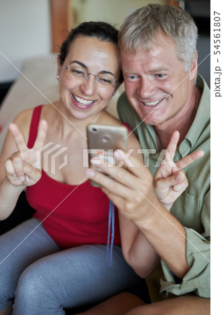 Middle-aged couple looking a mobile phone 54561807