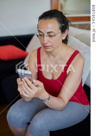 Young pretty woman at home with smart phone mobile 54561808