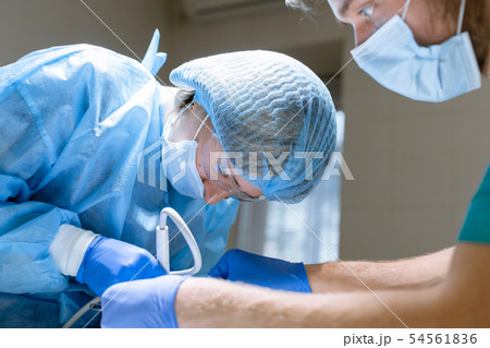 Surgical dentistry. A dentist surgeon treats and Surgical dentistry. A dentist surgeon treats and 54561836