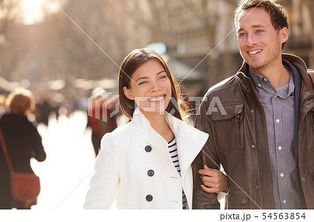 Urban modern young professionals couple walking Urban modern young professionals couple walking 54563854