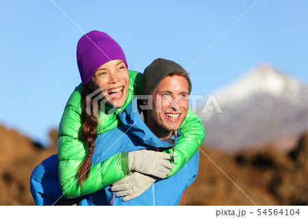 Couple piggyback happy in active lifestyle Couple piggyback happy in active lifestyle 54564104