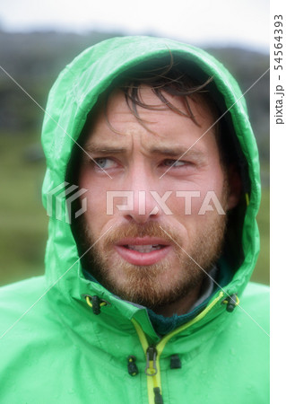 Raincoat - man outdoors in rain jacket 54564393
