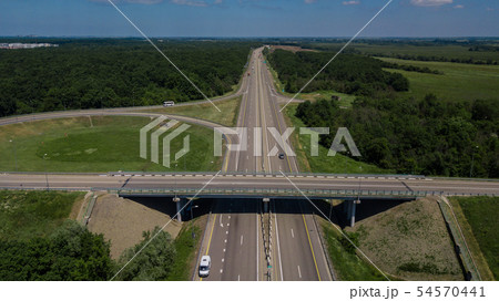 Aerial view of highway cloverleaf interchange seen from above. Aerial view of highway cloverleaf interchange seen from above. 54570441