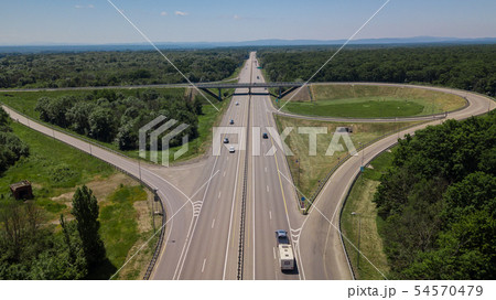 Aerial view of highway cloverleaf interchange seen from above. Aerial view of highway cloverleaf interchange seen from above. 54570479