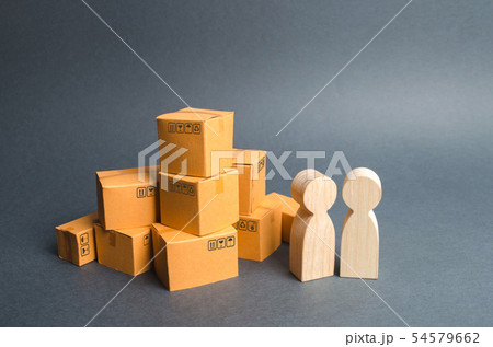 Two human figures stand near a pile of boxes 54579662